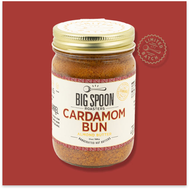 Jar of Big Spoon Roasters Cardamom Bun almond butter on a red background