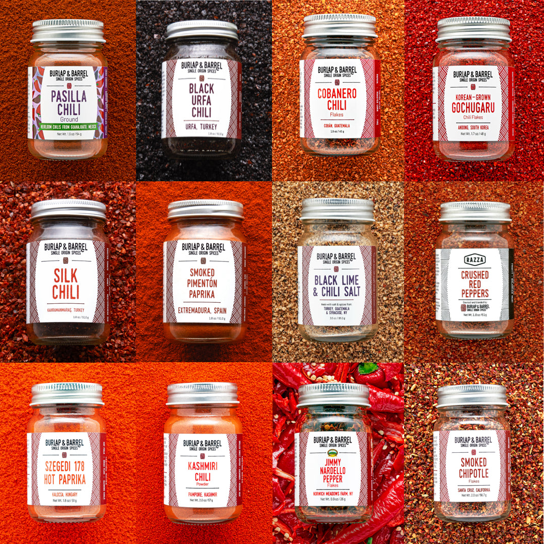 Grid of Burlap & Barrel chili jars with labels on a red chili pepper background