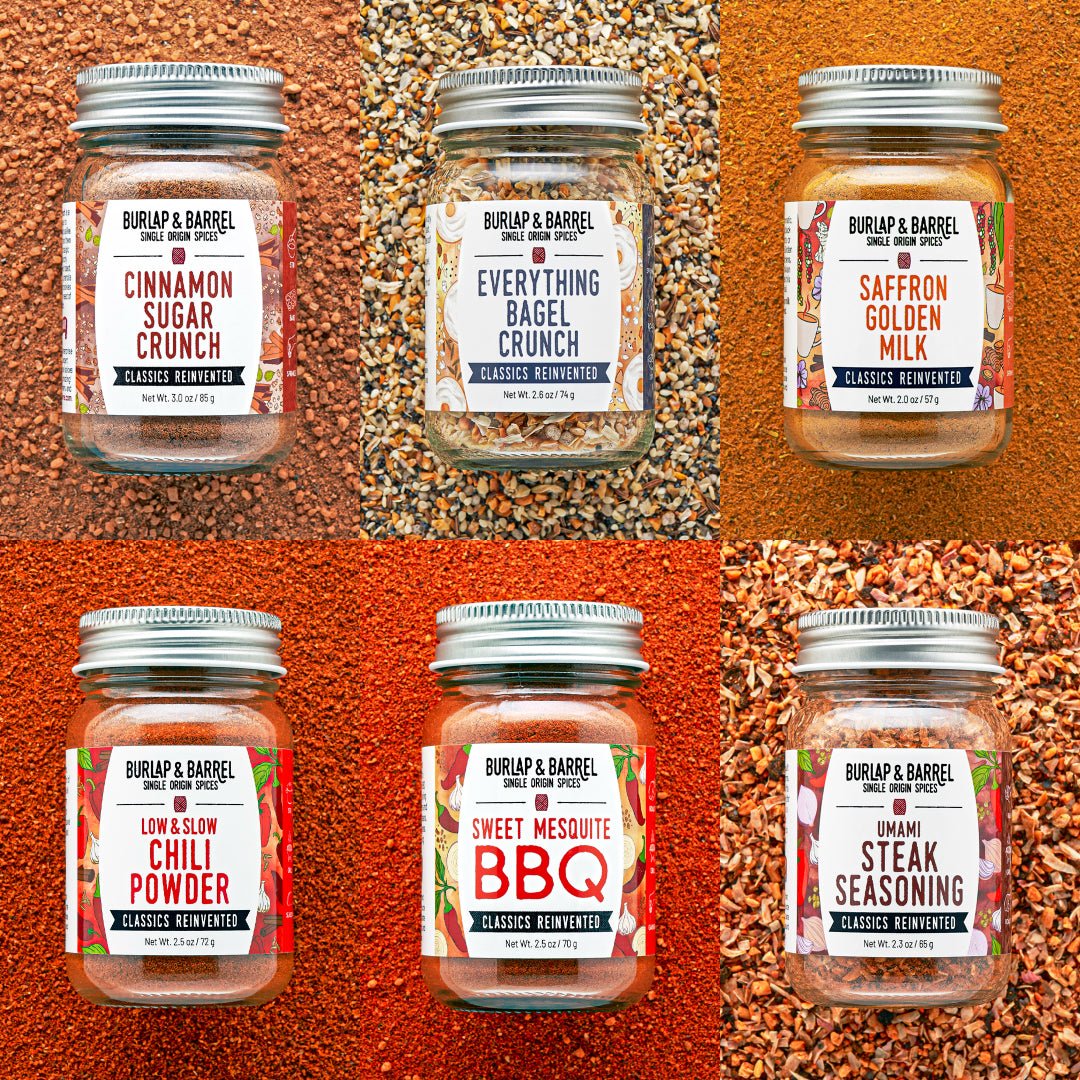 Jars of Burlap & Barrel seasoning mixes on a textured orange background