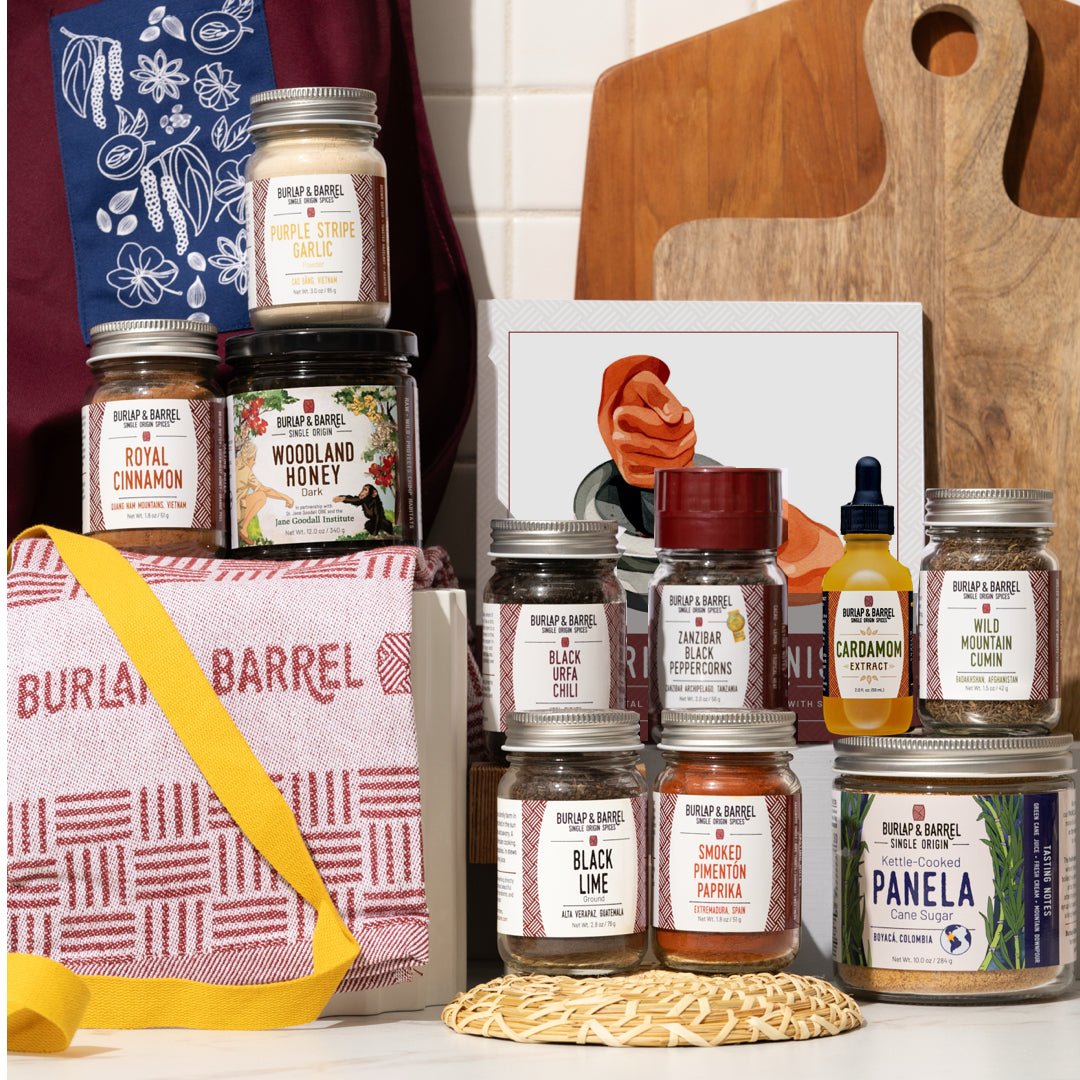 Collection of Burlap & Barrel products including jars and a bag on a wooden surface.
