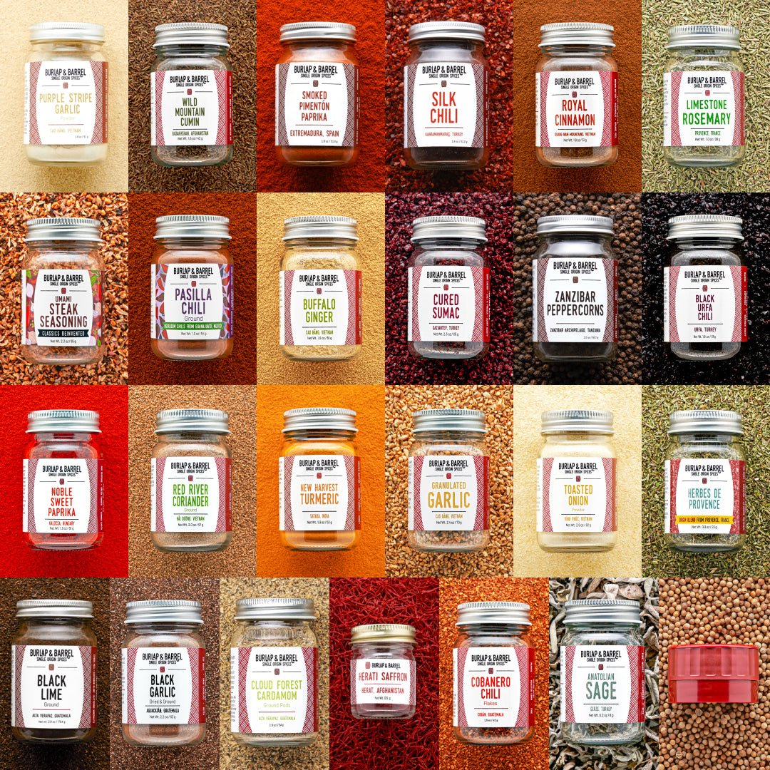 Grid of various jars of spices with labels on a textured background