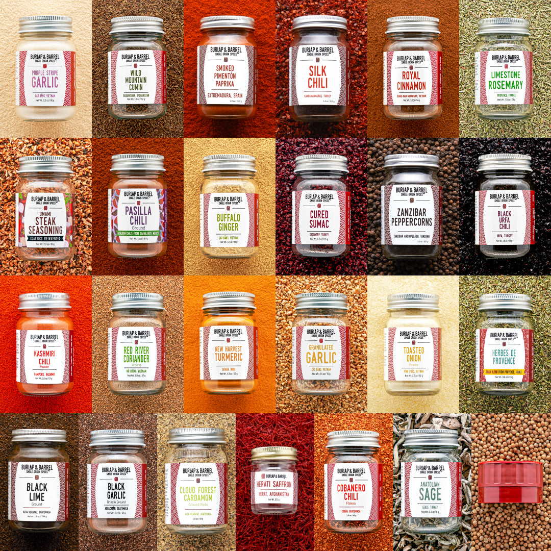 Grid of various jars of spices with Burlap Y Barrel labels on a textured background