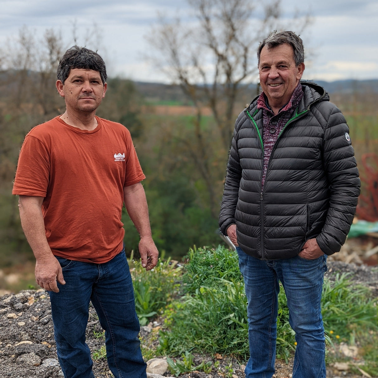 Two partner farmers, Joe and Luc standing in their herbs field in Provence, France.