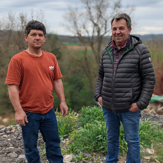 Two partner farmers, Joe and Luc standing in their herbs field in Provence, France.