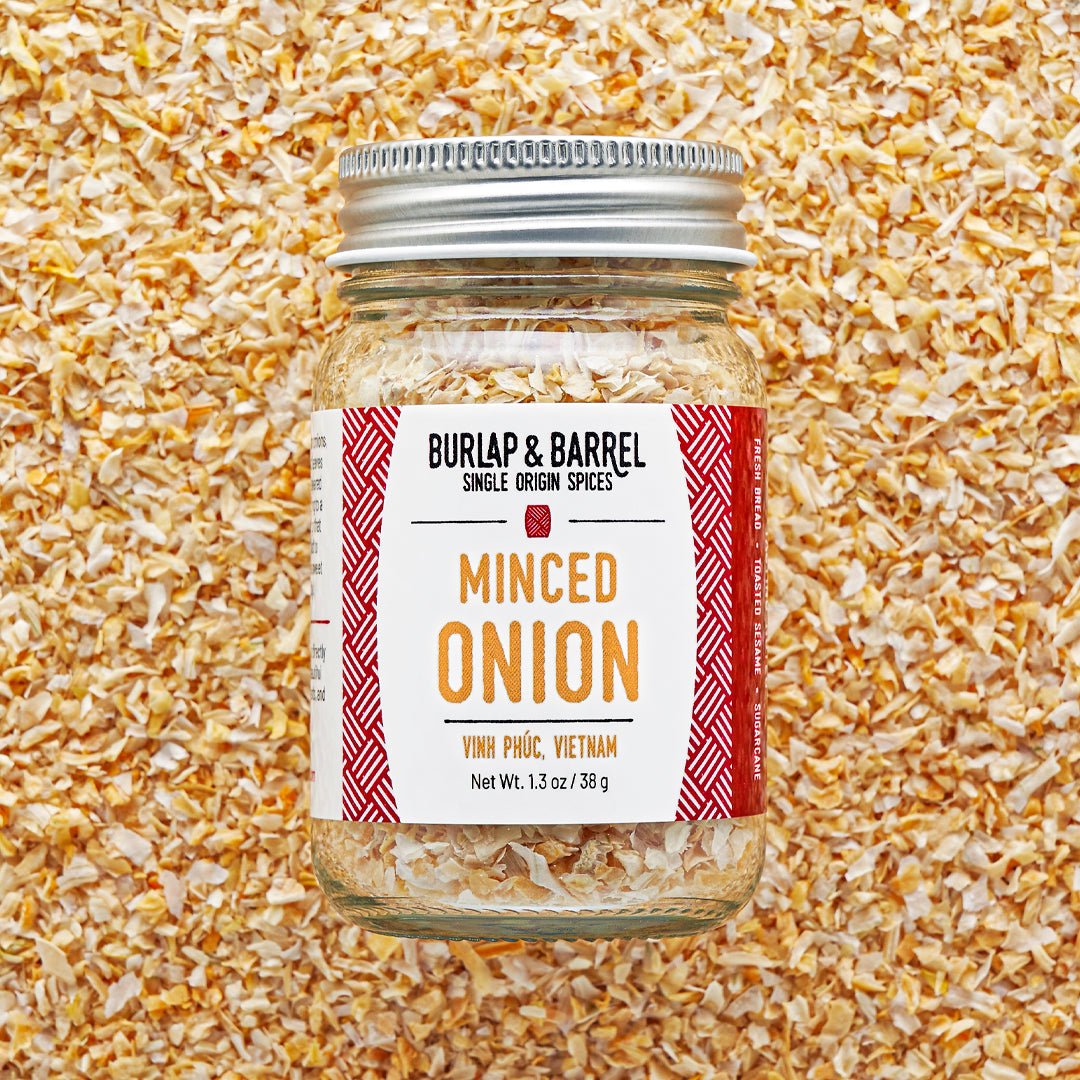 Jar of minced onion spice with 'Burlap & Barrel' label on a textured background