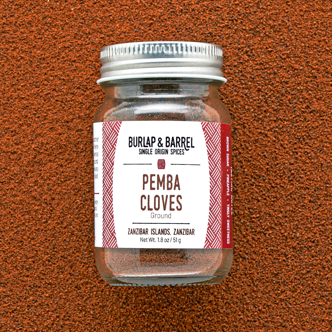 Jar of Burlap & Barrel Pemba Cloves on a brown textured background