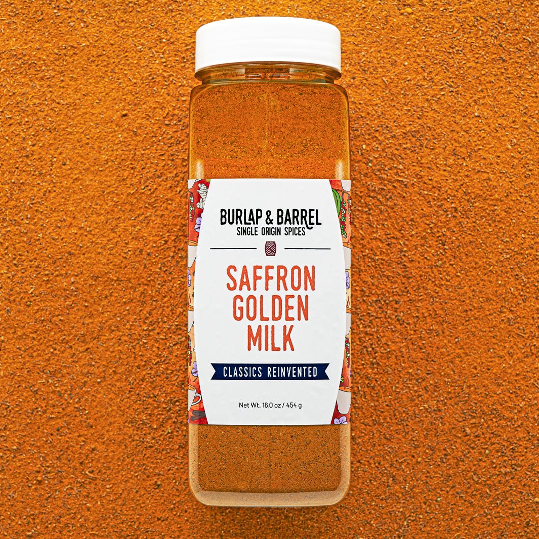 Container of Burlap & Barrel Saffron Golden Milk spice blend on an orange background