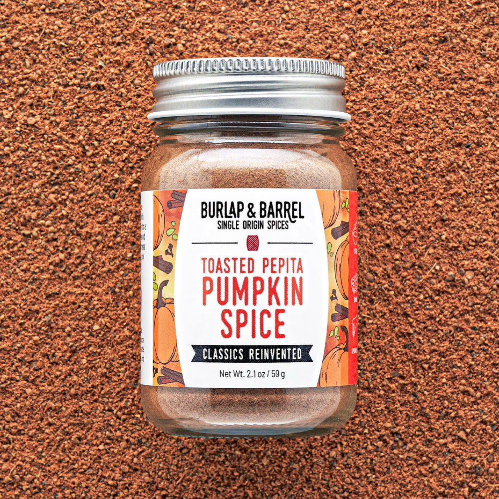 Jar of Burlap & Barrel Toasted Pepita Pumpkin Spice on a brown textured background