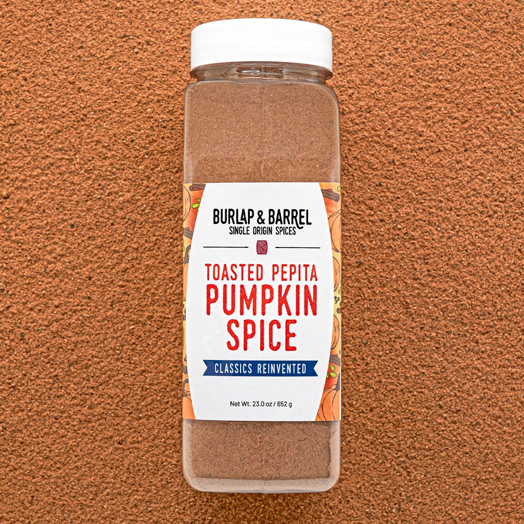 Container of Burlap & Barrel Toasted Pepita Pumpkin Spice on a brown background