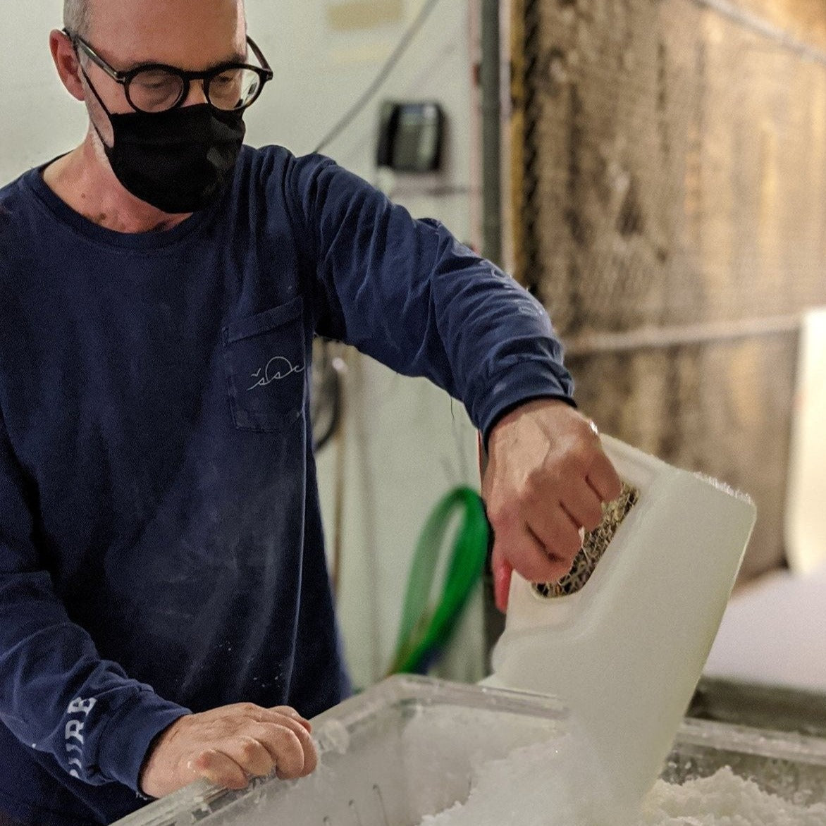 David sifting salt with a large scoop