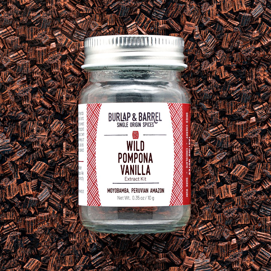 Wild Pompona Vanilla Extract Kit jar with white and red label on vanilla beans background
