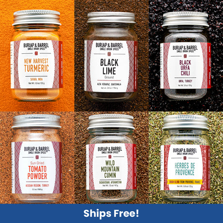 Collection of Burlap & Barrel spice jars with labels on a textured background