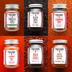 Collage of Burlap & Barrel chili jars with labels on a textured red background