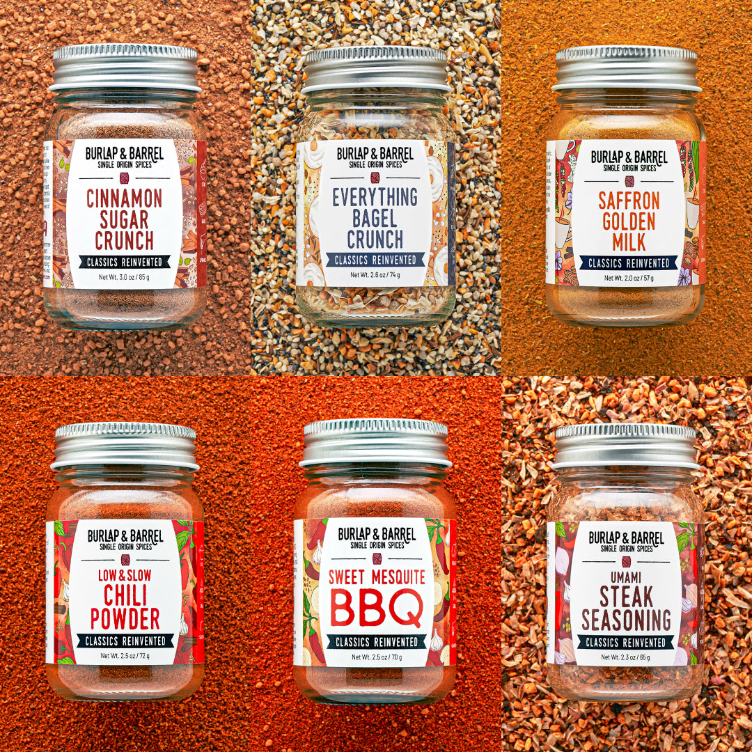 Jars of Burlap & Barrel seasoning mixes on a textured orange background