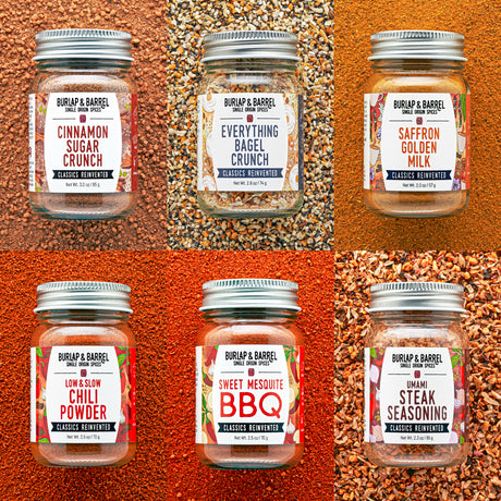 Jars of Burlap & Barrel seasoning mixes on a textured orange background