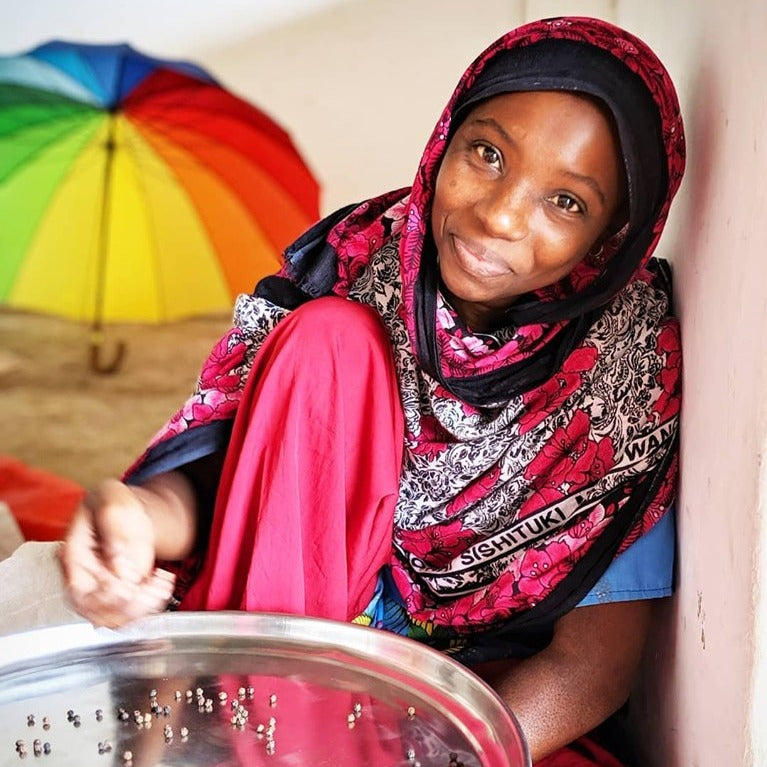 Partner farmer, Yumna sorting zanibar black peppercorns from Burlap & Barrel