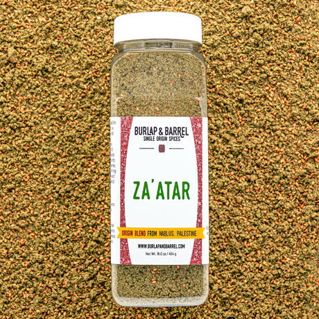 Bottle of Burlap & Barrel Za'atar spice blend on a textured brown background