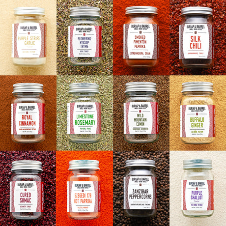 Grid of Burlap & Barrel spice jars with labels on a textured background