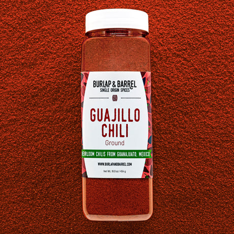 Container of Burlap & Barrel Guajillo Chili on a red background