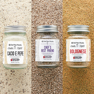 Three jars of Chef Marc Murphy pasta night seasoning on a textured surface