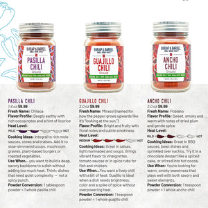 Three jars of ground  Mexican chili powder with labels on a white background from Burlap & Barrel