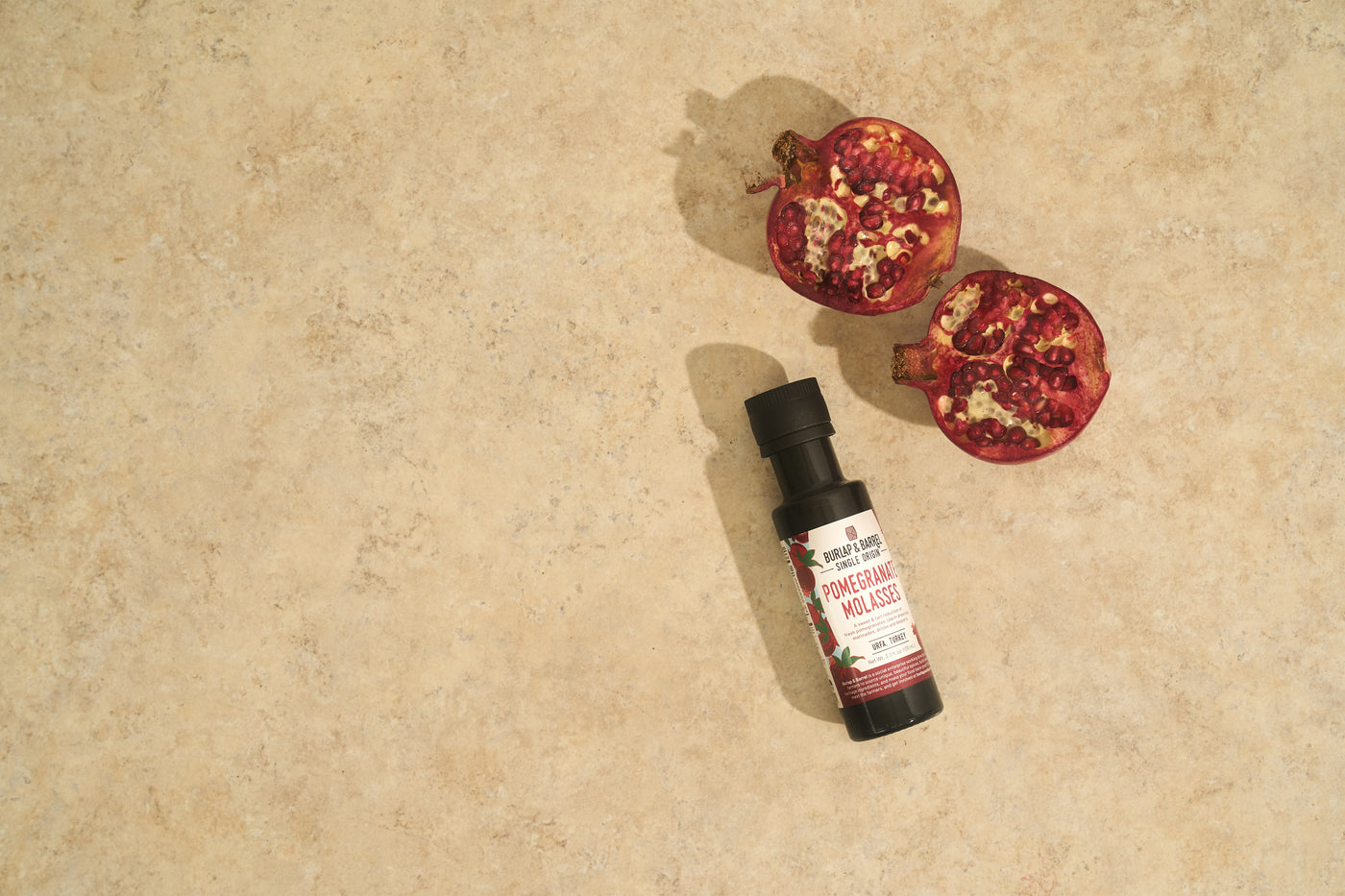 Pomegranate molasses from Burlap & Barrel and pomegranates 