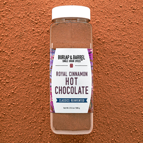 Bottle of Burlap & Barrel Royal Cinnamon Hot Chocolate on a brown background