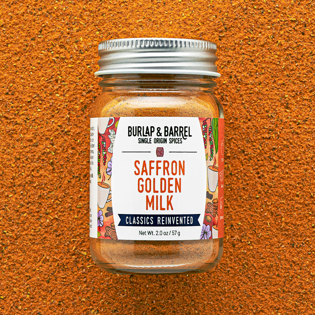 Jar of BURLAP & BARREL Saffron Golden Milk spice mix on a textured brown background