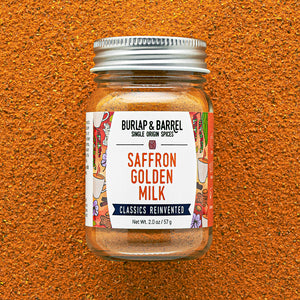 Jar of BURLAP & BARREL Saffron Golden Milk spice mix on a textured brown background