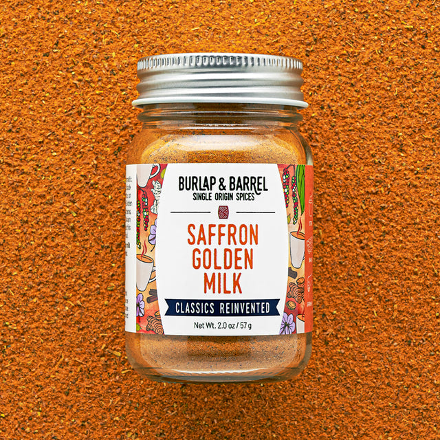 Jar of BURLAP & BARREL Saffron Golden Milk spice mix on a textured brown background