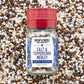 A bottle of Burlap & Barrel Salt & Peppercorn Medley spices, featuring a red cap and a white label with blue patterns, set against a background of mixed whole peppercorns.