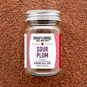 Jar of Burlap & Barrel Sour Plum Powder on a textured brown background