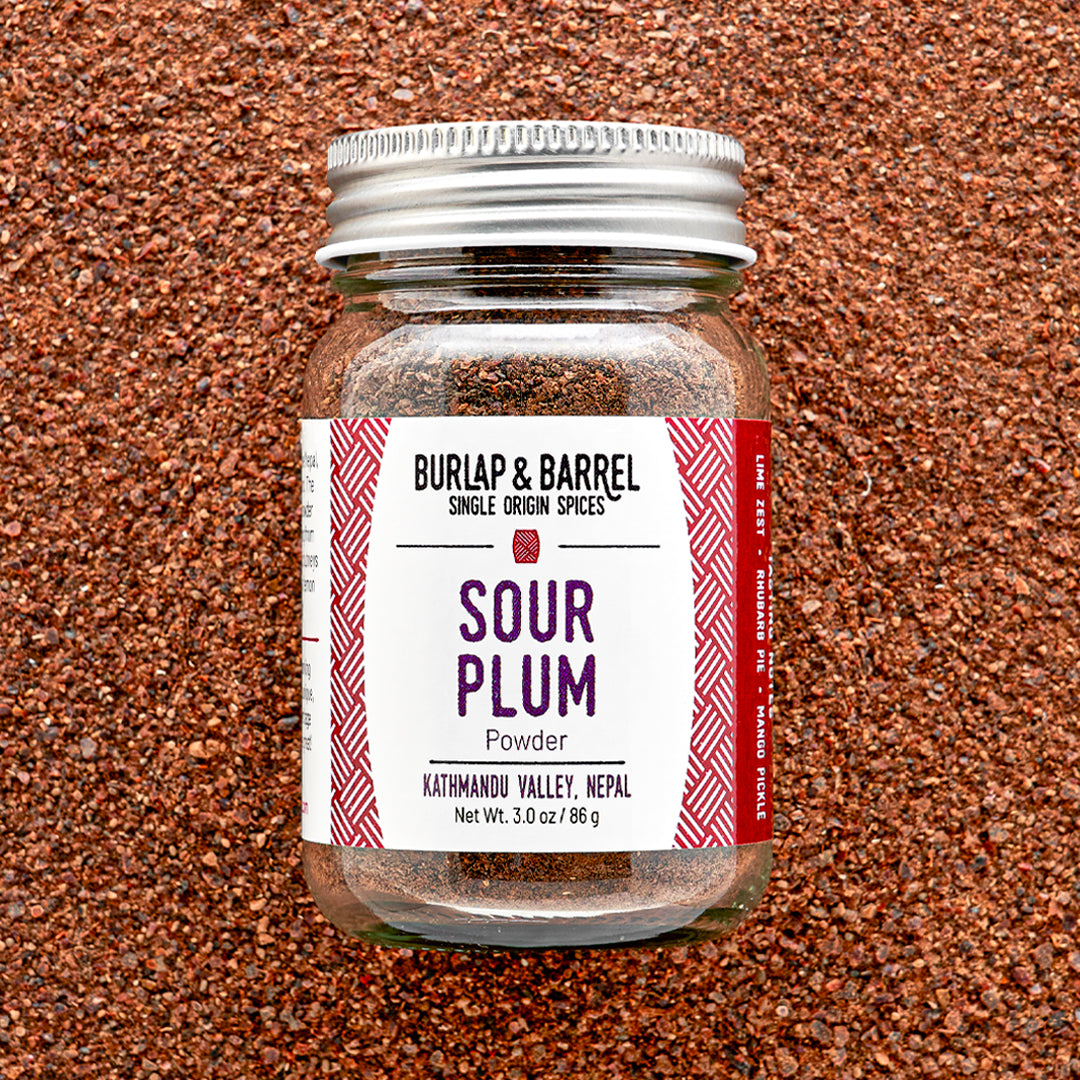 Jar of Burlap & Barrel Sour Plum Powder on a textured brown background