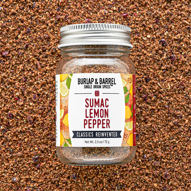 Jar of Burlap & Barrel Sumac Lemon Pepper on a textured brown background
