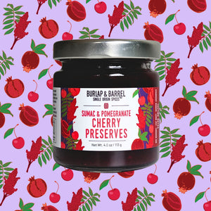 Jar of Burlap & Barrel Sumac & Pomegranate Cherry Preserves on a patterned background