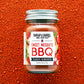 Jar of Burlap & Barrel Sweet Mesquite BBQ spice blend on a red background