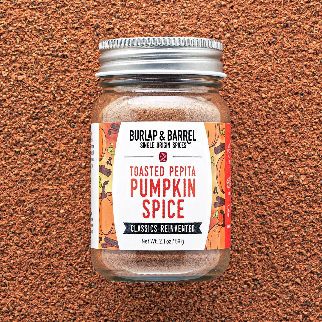Jar of Burlap & Barrel Toasted Pepita Pumpkin Spice on a brown textured background