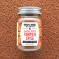 Jar of Burlap & Barrel Toasted Pepita Pumpkin Spice on a brown textured background